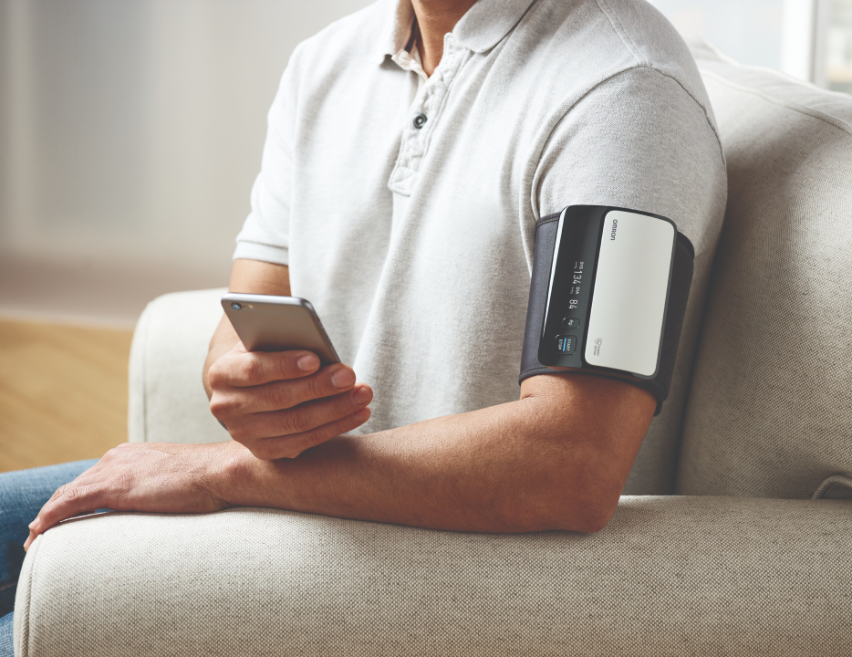 Man using the Omron BP monitor